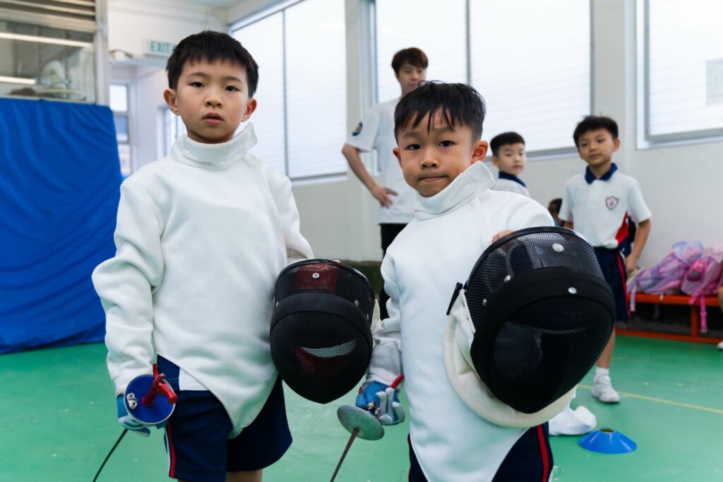 在一個人人都在問「成績怎樣衝上去」的年代，聖公會聖米迦勒小學｜鄧子健校長把話題帶到更根本的位置：孩子為什麼要學？如果連自己想成為怎樣的人都未想清楚，再漂亮的分數都可能只是一段被推着走的路。他不介意談自己的「不完美」——年少時頑皮、讀書只求「夠用」、曾把賺錢當作最重要的指標；也不避諱說自己如何在一次次被提醒、被挑戰後，慢慢學會謙卑，學會用「關係」和「信任」去帶領一間學校。這次專訪，記錄他如何把興趣與夢想變成孩子看得見、摸得到的學習經驗；也記錄他如何用一份家長問卷、七十多位家長親自回電，把「我願意聽」變成「我真的做到」。讀到最後你會明白，他想打造的不是一間只擅長催谷孩子成績的學校，而是一個讓孩子每天願意走進來、並且敢於想像未來的地方。